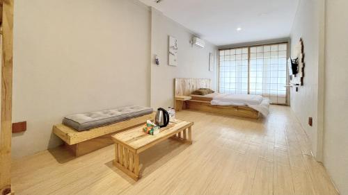 a large room with two beds and a table at The Kanzi Hotel & Village in Cipayung