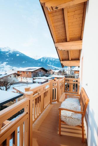 a balcony with a view of snow covered mountains at Chalet Bergglück in Piesendorf