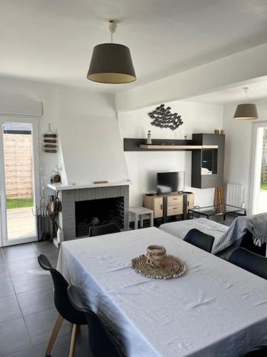 un salon avec une table et une cheminée dans l'établissement Villa des 4 saisons, à Cucq