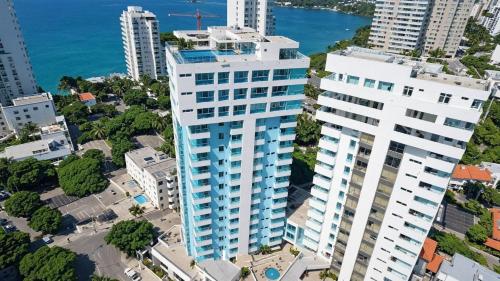 an aerial view of a tall white building at Apartamentos Neos - Cerca al Mar by SOHO in Santa Marta