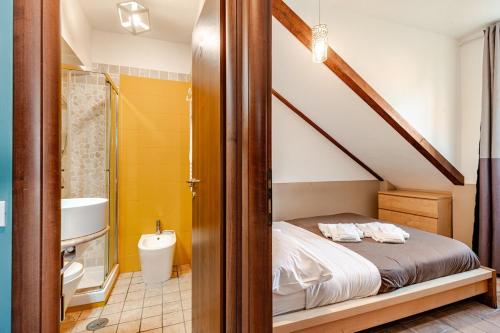 a bedroom with a bed and a bathroom with a shower at Oasi di Mare next Rome Airport in Fregene