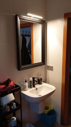 a bathroom with a white sink and a mirror at Ocean View Malpica VUT in Malpica