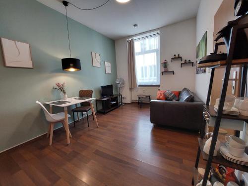 a living room with a couch and a table at Zigarrenhof Apartment in Citynähe inkl. Netflix in Aschaffenburg