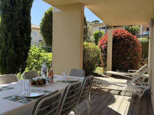 a table and chairs sitting on a patio at T3 Cote Plage n 19 by Pinarello Villa Services in Pinarellu