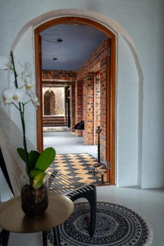 a room with a hallway with a table and a doorway at Yzerfontein 3 Bed House with Pool & Sea Views in Yzerfontein