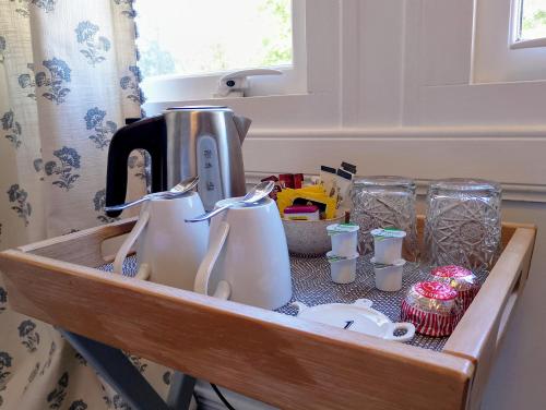 a tray with cups and utensils in a kitchen at Smiddy House in Spean Bridge