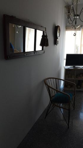 a chair sitting in a room with a mirror at Mi Lugar en el Mundo in Buenos Aires