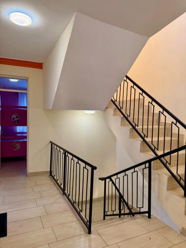 a staircase in a house with a stair case at Greenwood Garden 3Bedroom Mtwapa in Mtwapa