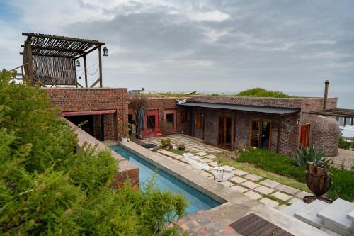 a house with a swimming pool in the yard at Yzerfontein 3 Bed House with Pool & Sea Views in Yzerfontein