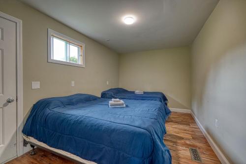a bedroom with a bed with a blue comforter at 201 Cabins in Jackman