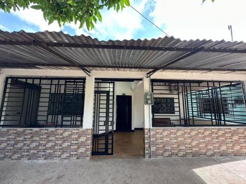 a brick house with a black roof at Las Reinas House Rental in Inírida