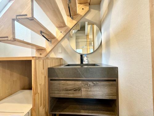 a bathroom with a sink and a mirror at Hakuba Sun Valley Hotel in Hakuba