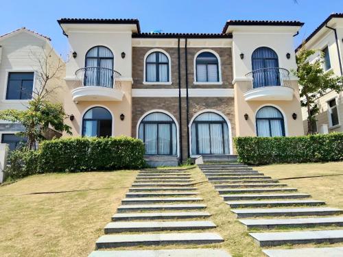 a house with stairs in front of it at Happy Stay Resort Wonderland Ho Tram in Xuyên Mộc