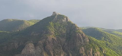a mountain with a castle on top of it at Babi la tappa di novaretto in Caprie