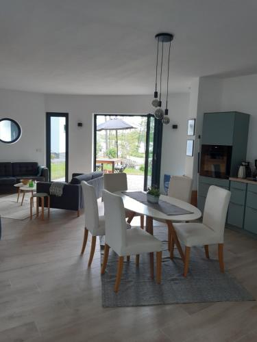 a dining room and living room with a table and chairs at Ihre Auszeit am See in Lychen