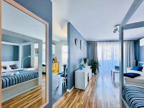 a bedroom with a bed and a mirror at Apartment 19 - Aquapark Reda in Reda