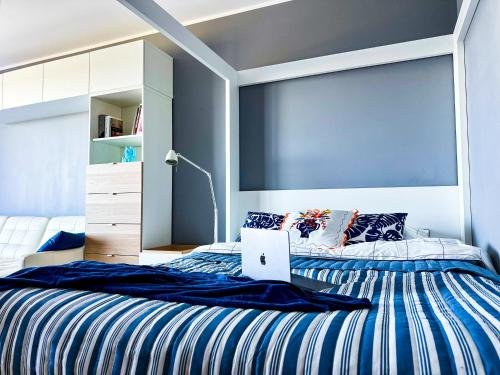 a bedroom with a bed with a laptop on it at Apartment 19 - by Aquapark Reda in Reda