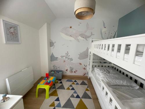 - une chambre pour enfants avec des lits superposés et un lit bébé dans l'établissement Maison Familiale de Centre-Ville, à Dives-sur-Mer