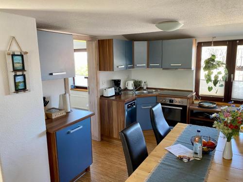 a kitchen with a table and a dining room at Gold Fehmarn in Fehmarn