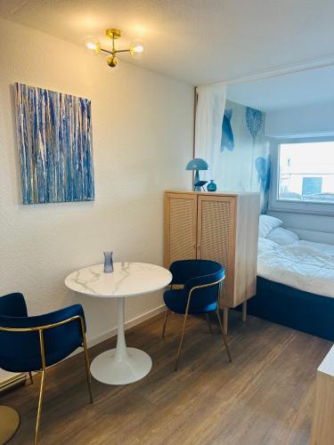 a small room with a table and chairs and a bed at Ferienstube Norderney in Norderney