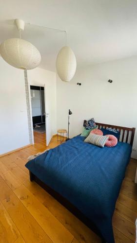 a bedroom with a blue bed with two pillows on it at Apartament w Centrum in Przemyśl