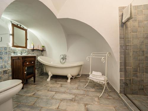 a bathroom with a tub and a toilet and a sink at El Conventillo de San Roque in San Roque