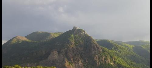 a mountain with a tower on top of it at Babi la tappa di novaretto in Caprie