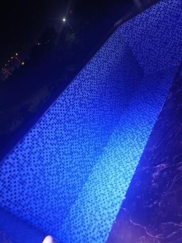 a close up of a blue light on a table at 2 BHK Dreamy Nest With Private Pool in Greater Noida