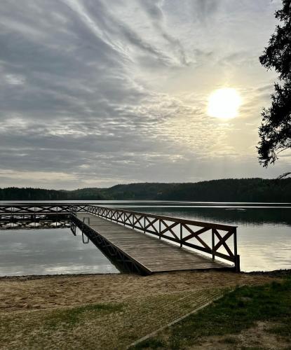 a wooden bridge over a body of water at Gryfne Kaszuby in Kamienica Królewska
