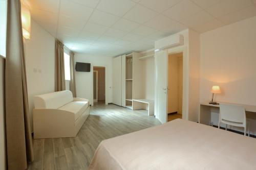 En eller flere senge i et værelse på Sabbia d'Oro locanda & beach