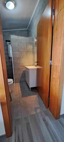 a bathroom with a sink and a toilet at 3BL Retreat - Escape & Poolparty in Praia da Vitória
