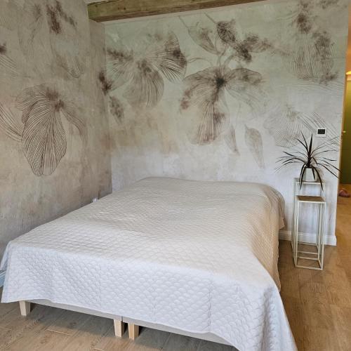 a bedroom with a bed with a wall with dandelions at Lawendowy Raj in Pilchowice
