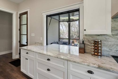una cucina con armadi bianchi e un grande piano di lavoro di Harpers Retreat - Barrel Sauna and Fire Pit! a Harper's Ferry