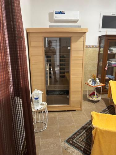 a room with a glass door with a man in the reflection at Casa Vacanze Cimorelli in Venafro