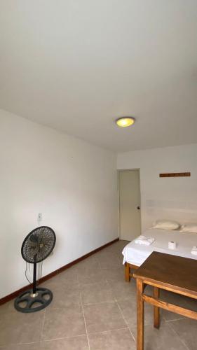 a room with a bed and a table in it at Hospedaje Rio Hotels Mancora in Máncora