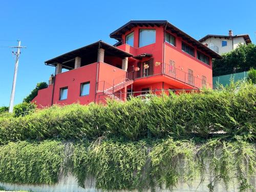 a red house sitting on top of a hill at Heavenly Abode - Barbaresco in Barbaresco