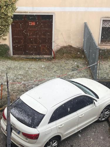 a white car parked in front of a house at Piccolo chalet in Andalo