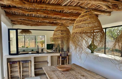 a kitchen with a counter with a sink and windows at Palais Bleu Nomade Essaouira in Aït Imouni