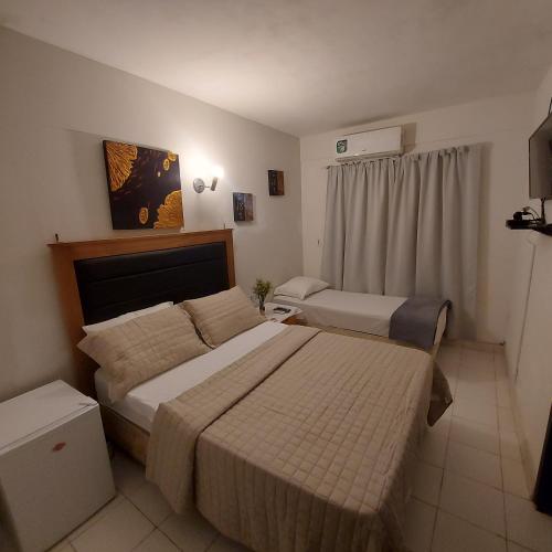 Postel nebo postele na pokoji v ubytování CENTRAL RIVIERA HOTEL Asunción