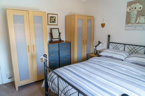 a bedroom with a bed and a dresser at George Street Beverley in Beverley