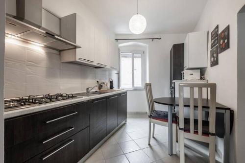 a kitchen with a table and a sink and a stove at Peaceful Hub Saturnia in Manciano