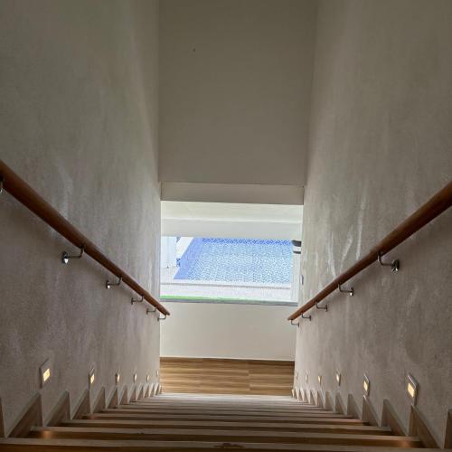 a stairway with a view of a swimming pool at Eleven25 Roomstay in Dungun
