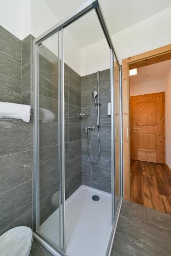 a shower with a glass enclosure in a bathroom at Hotel Maloja Kulm in Maloja