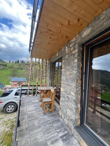 a patio with a table and chairs on a building at Villa Roni in Peje