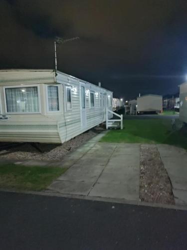 a house sitting on the side of a street at night at G26 kirbys Retreat 2 in Skegness