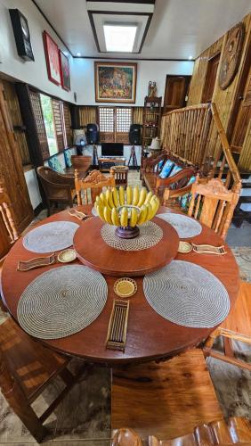 a wooden table with a bowl of bananas on it at Josephine's Villa - Bangar, LU (up to 15 guests) in Bangar