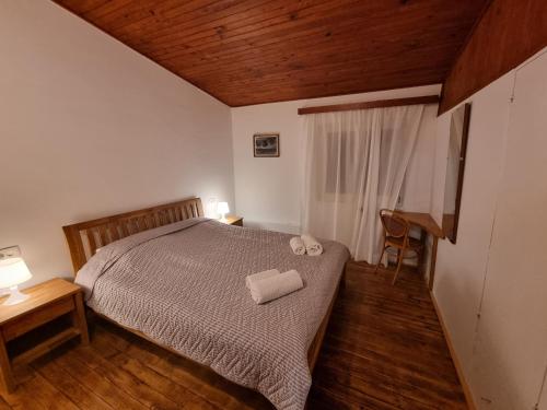 a bedroom with a bed with two towels on it at Holiday house Maja in Baška