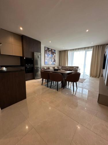 a kitchen and dining room with a table and chairs at Sea breeze Park Residens 2 in Nardaran