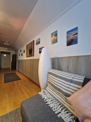 a living room with a couch and pictures on the wall at Stationshuset Dalarna Apartments in Sörsjön