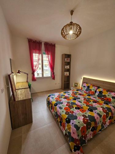 a bedroom with a bed with a colorful comforter at Da Camilla in Cagliari